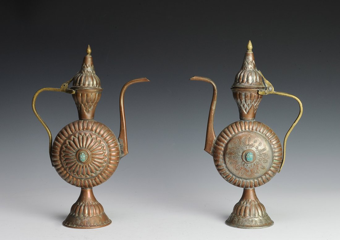 Pair of Pewter Ewers: This pair of Middle Eastern style ewers are made of pewter and inlaid with Persian turquoise. The dimensions are 8 inches wide by 12 inches high. All measurements are approximate. Condition: The are t