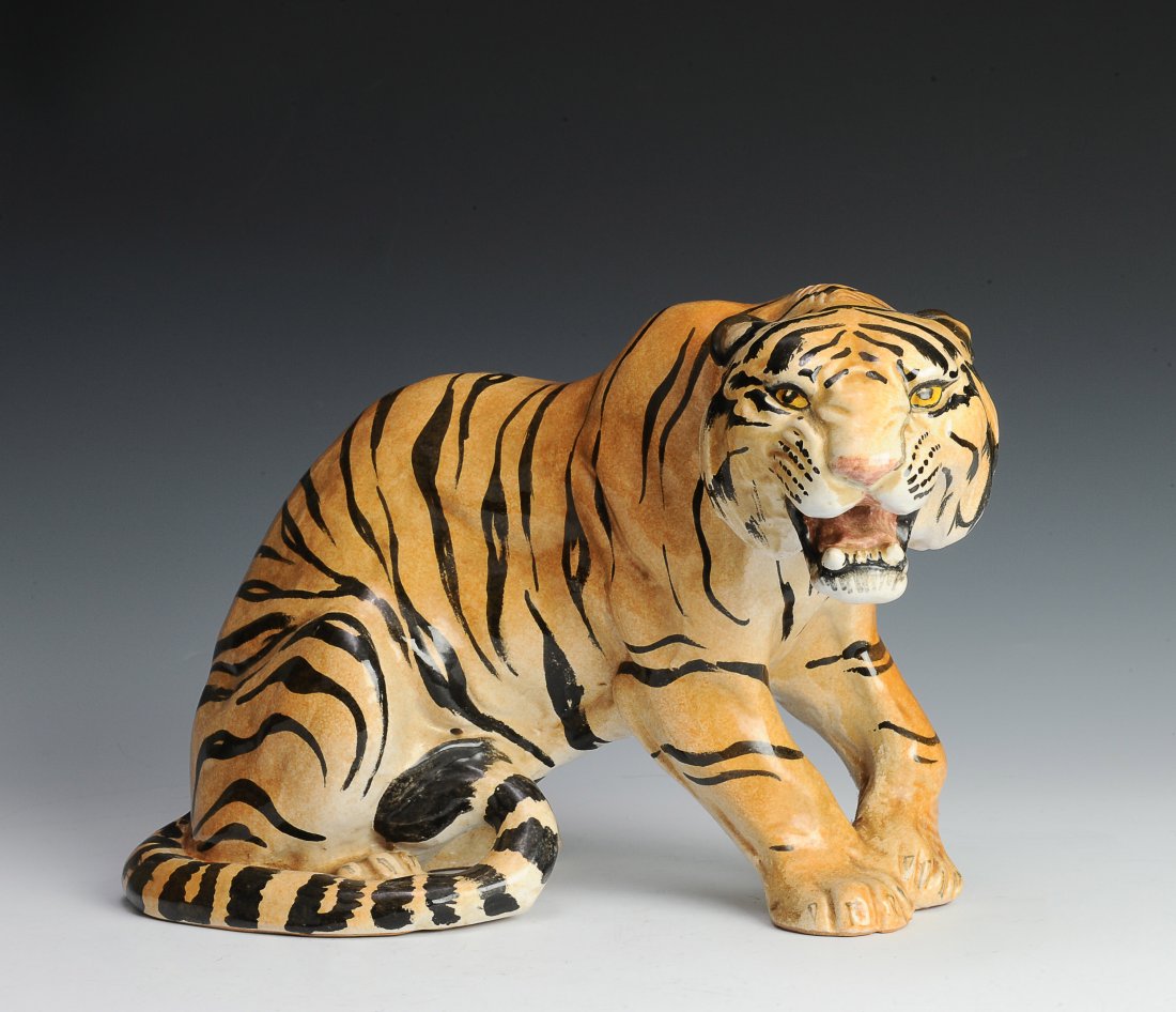 Vintage Porcelain Tiger Figure, Italy: Crouching porcelain tiger figure stamped with "Made in Italy". This vintage tiger has a dynamic pose and is well painted. The dimensions are 15 inches long by 9 1/2 inches high. All measurements are a