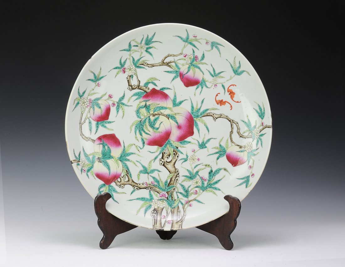 Large White Ground Peach Charger: Large charger painted with peaches. This white ground charger is painted with a peach tree including the branches, leaves, flowers, and peaches. Two bats are also painted on the face. The plate has a 