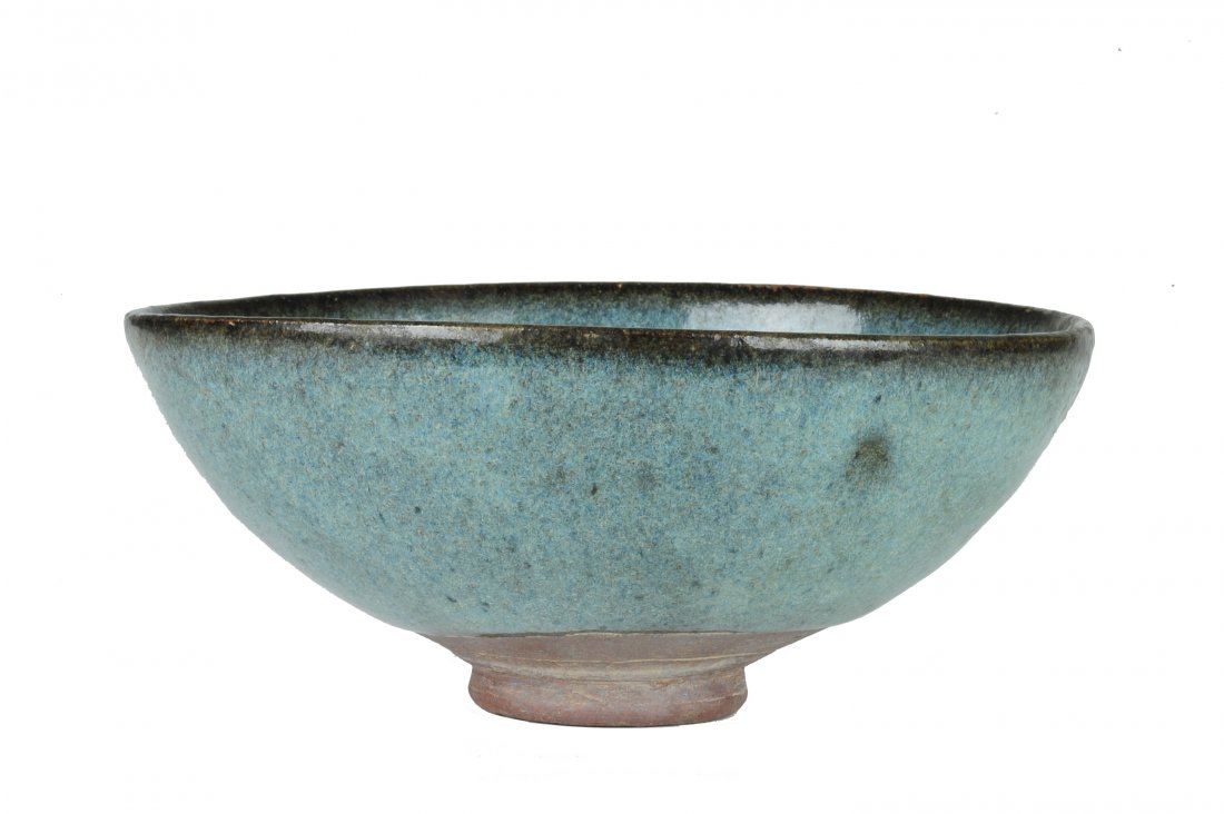 Jun Glazed Bowl, Ming or Earlier: Jun glazed bowl from the Ming dynasty or earlier. It has a pale blue glaze with a dark brownish- black glaze around the rim. There is a 1 7/8 inch wide by 2 5/8 inch area of purple area on the interio
