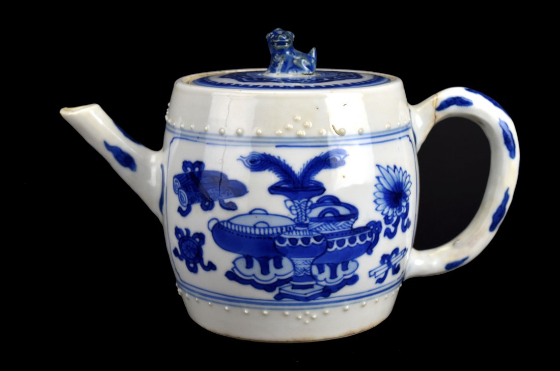 Blue & White Teapot, Kangxi Period: Chinese blue and white teapot from the early 18th century. This Kangxi Period teapot features raised nodules in bands above and below two vignettes depicting the Eight Buddhist symbols. The finial on 