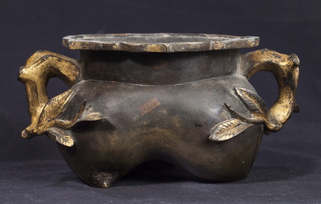 Gilt Bronze Incense Burner, 18th-19th Century: Gilt bronze peach shaped incense burner from the 18th - 19th century. This cast bronze incense burner is in the form of a peach with leaves. The lip resembles a lotus flower. Dimensions are 6 inches w