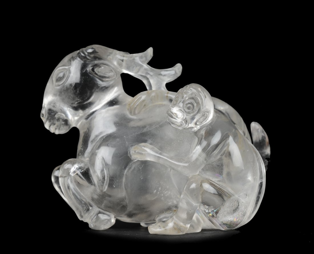 Carved Crystal Snuff Bottle, 19th Century: Chinese carved crystal deer and monkey snuff bottle from the 19th century. The cap is cleverly placed in the deer's tail, and the openwork antlers are pointed backwards. The monkey's hands, also openw