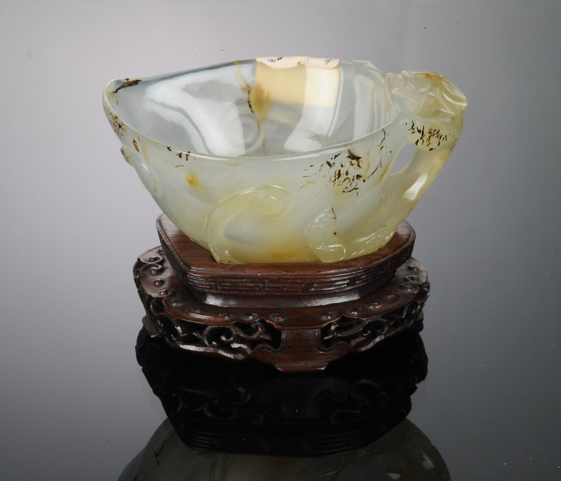 Agate Cup with Chilong Handle, Ming Dynasty: Carved agate cup from the Ming Dynasty. Cup is carved translucent, black and brown agate. It has a partially openwork and bas-relief chilong handle. The chilong's head and arms hold on to the rim of t