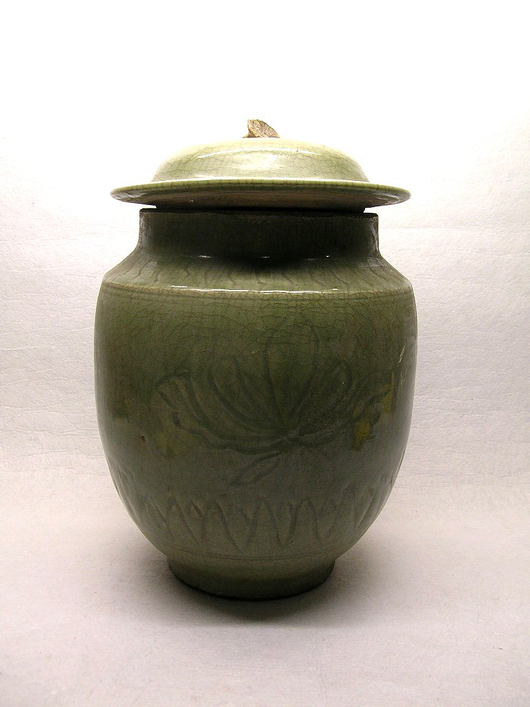 Large Ming Dynasty Longquan Jar #la040rg: Of heavily potted ovoid form with a short neck, decorated with large incised floral motifs, a mushroom-shaped finial to the lid, overall covered with Longquan green tone under a network of transparent