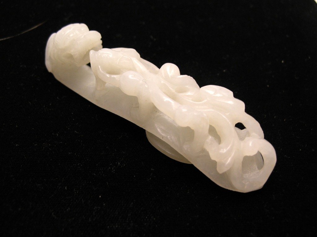 Chinese White Jade Dragon Belt Hook #la192j: An unusual Chinese carved white jade belt hook decorated with dragon motifs, 18th century, stone of an even white tone, aged wear, edge nicks, fissures and possible repair, with Southey\'s label, 3 1/