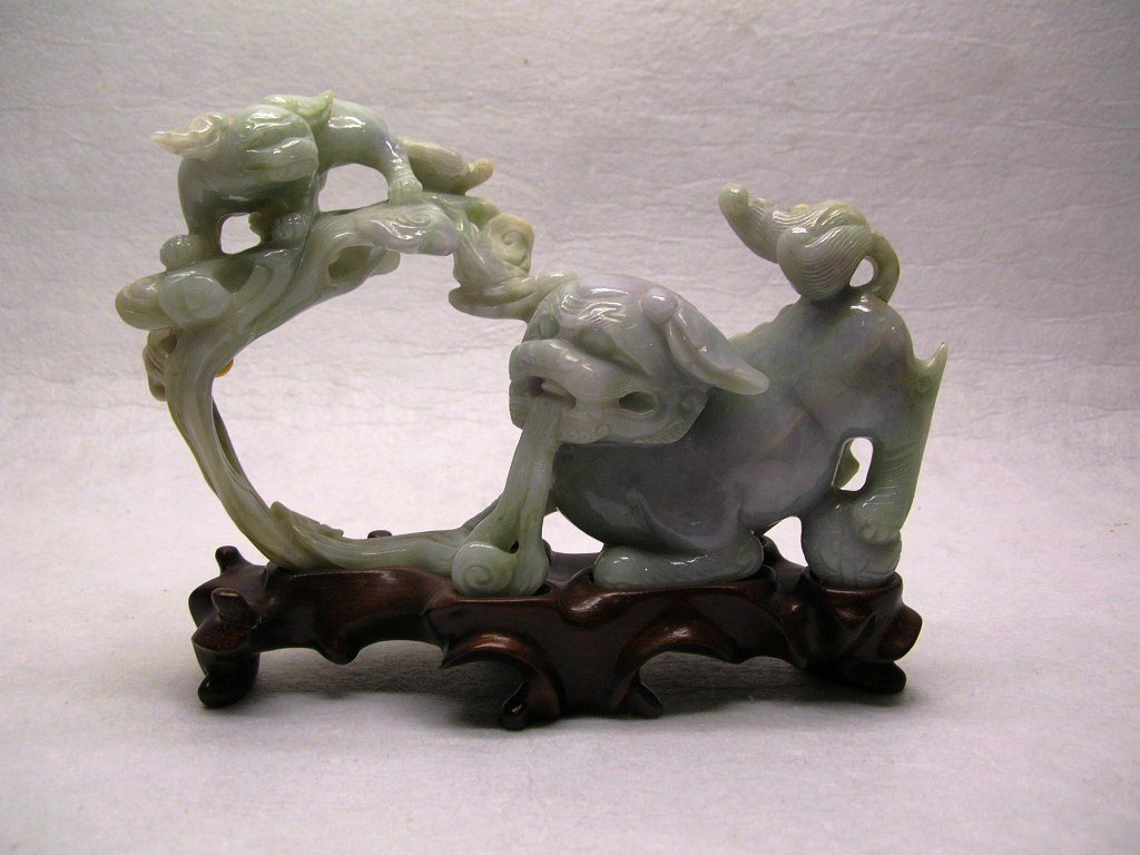 Chinese Carved Jadeite Group of Two Lions #la264srb: An unusual Chinese carved jadeite group of two Buddhist lions (Foo dogs), jadeite stone of pale celadon tone with some russet and lavender color, carved hardwood base, 20th century, good condition, 7 