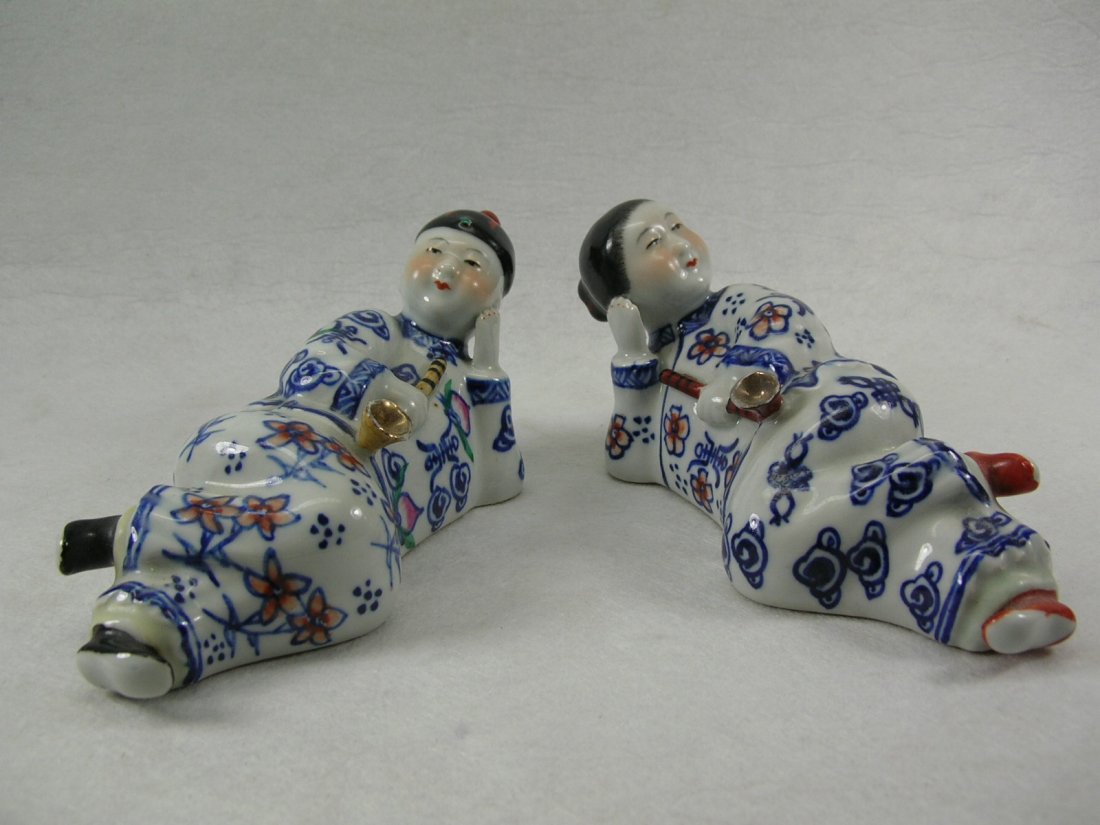 Chinese Doucai Porcelain Figures of Man and Woman: Chinese Doucai glazed porcelain figures of reclining man and woman holding opium pipes, good condition, 7" wide