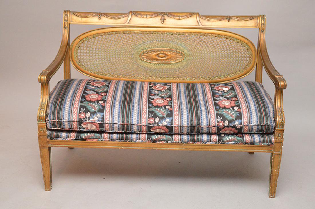 Gold color, settee with drape motif crest, caned oval: Gold color, settee with drape motif crest, caned oval back with fan carving in center, 34"h