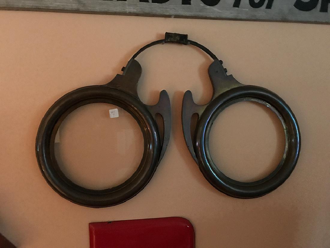 Advertising brass eyeglass frame, 31"w x 21"h (one: Advertising brass eyeglass frame, 31"w x 21"h (one glass missing)
