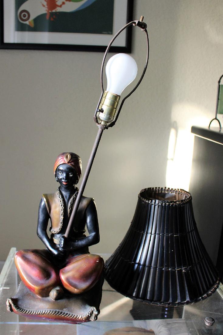 Seated blackamoor lamp, painted metal with bamboo: Seated blackamoor lamp, painted metal with bamboo shade, 26"h