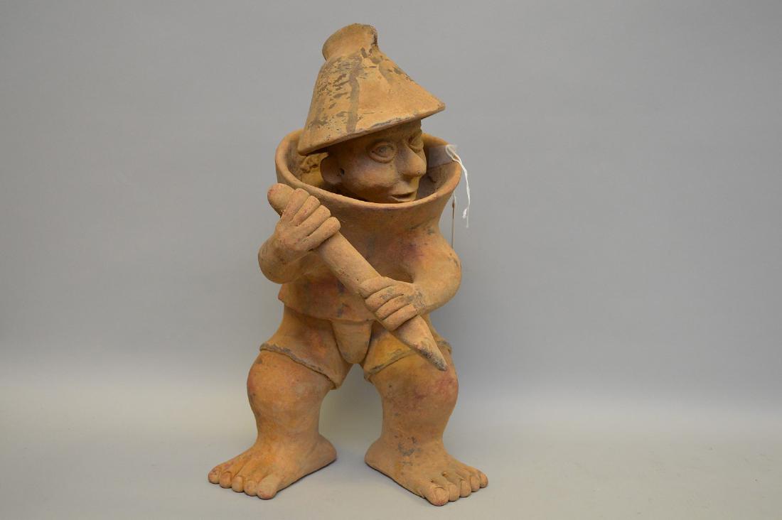 Jalisco Warrior Pottery Sculpture Pre-Columbian.: Jalisco Warrior Pottery Sculpture Pre-Columbian. Mexico. 17" h x 9.5" w. Sculptured warrior with hat & armor, holding a mace. Interesting and unusual face, feet have detailed toenails. Evidence of red