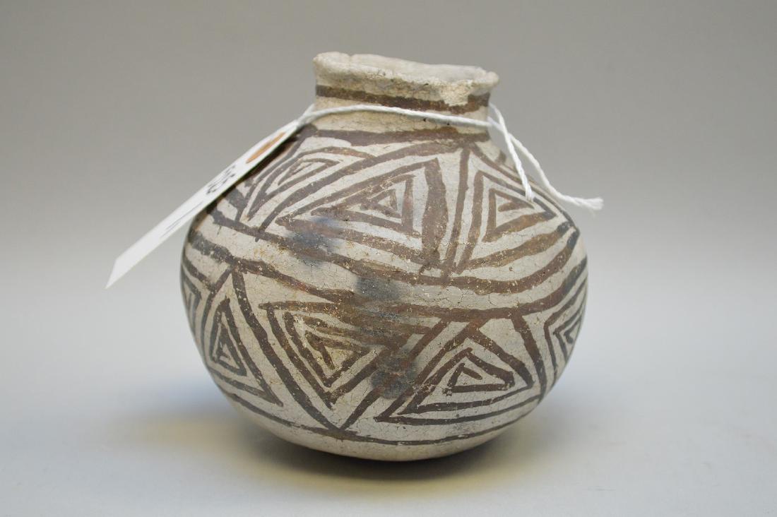 Puerco Black-on-White Pottery Olla Pueblo Anasazi: Puerco Black-on-White Pottery Olla Pueblo Anasazi Ancient Native American (ca ~850 AD - 1000 AD) 4.5" h Condition: Some chips on rim, design clear, but some crazing of slip appropriate to ancient use.