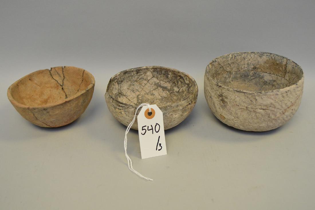 Three Native American Salado Pottery Bowls Tonto: Three Native American Salado Pottery Bowls Tonto Basin, AZ (ca ~1200 AD). Two of the bowls are red with black smudged interior. The smallest bowl is a plainware. Smallest 5" dia; largest 5.5" dia x 3.