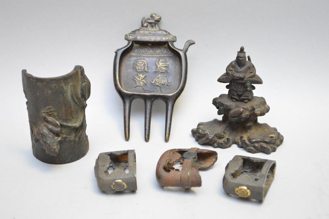 Six Asian Bronze Articles - Lot includes three sword: Six Asian Bronze Articles - Lot includes three sword toppers (two are identical 1" x 1 3/8"), a fragment with a frog figure 2 1/2" h, a samurai figurine 2 5/8", and an unidentified pronged object 3 3/