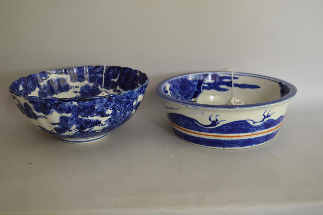 Two Blue & White Asian Porcelain Bowls - Blue & white: Two Blue & White Asian Porcelain Bowls - Blue & white bowl with scalloped rim features a phoenix & foliage on central medallion and continuous imagery of a tree-filled landscape, unmarked 9 1/2" diame