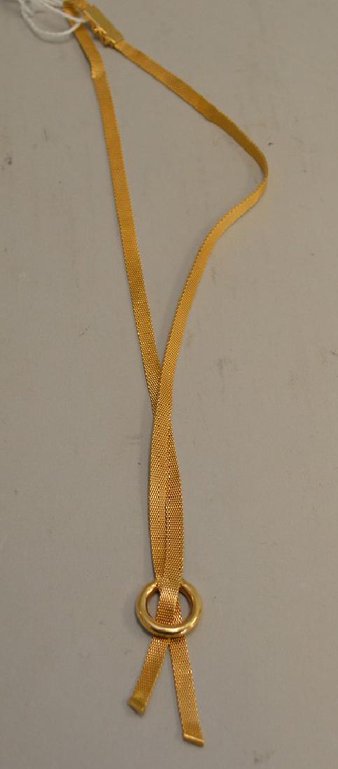 18 KT Gold Mesh Lariat with Round Ring Necklace - 3/16": 18 KT Gold Mesh Lariat with Round Ring Necklace - 3/16" width mesh comes down through a central gold ring. Necklace when clasped and doubled, measures 9 1/2" long. Slide in clasp with latch. Weighs 17