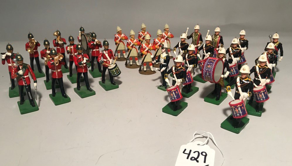 COLLECTION OF 31 MILITARY BAND TOY SOLDIERS: COLLECTION OF 31 MILITARY BAND TOY SOLDIERS - Includes: fourteen by Britain in blue uniform w/white helmet band members; eleven by Britain in red uniform band members; six in orange uniform by unknown