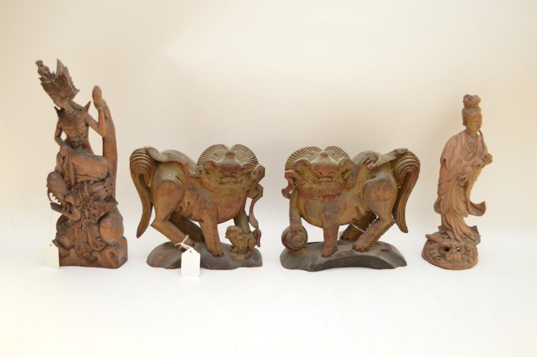 FOUR ANTIQUE ASIAN CARVED WOOD FIGURES - Includes: a: FOUR ANTIQUE ASIAN CARVED WOOD FIGURES - Includes: a Chinese Guanyin on dragon head with glass eye accents 11” H (one eye on dragon is missing); an Indonesian female figure on dragon 13” H (small 