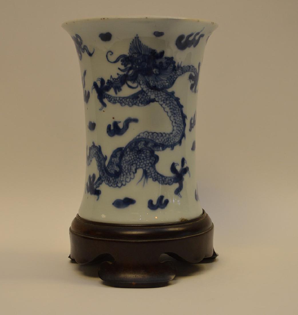 CHINESE BLUE & WHITE PORCELAIN VASE - with custom wood: CHINESE BLUE & WHITE PORCELAIN VASE - with custom wood stand. Features phoenix and dragon imagery. Condition: a few small ships to rim and base. Some small paint splatters. Dimensions: 6” H, 7 1/2��