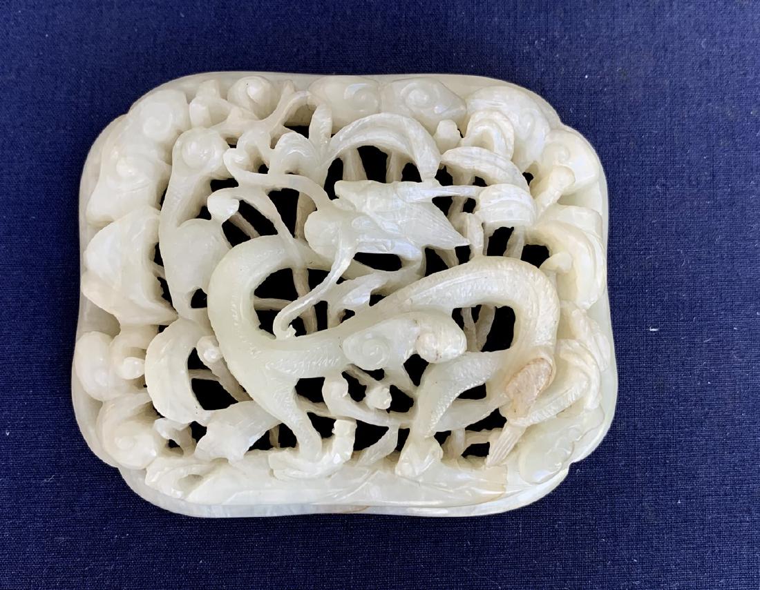 Antique Chinese White Jade Medallion depicting a dragon: Antique Chinese White Jade Medallion depicting a dragon in foliage. Condition: good with no cracks or chips. The piece has two minor inclusions which can be seen in the photos. 3 1/4" x 2 5/8". Proven