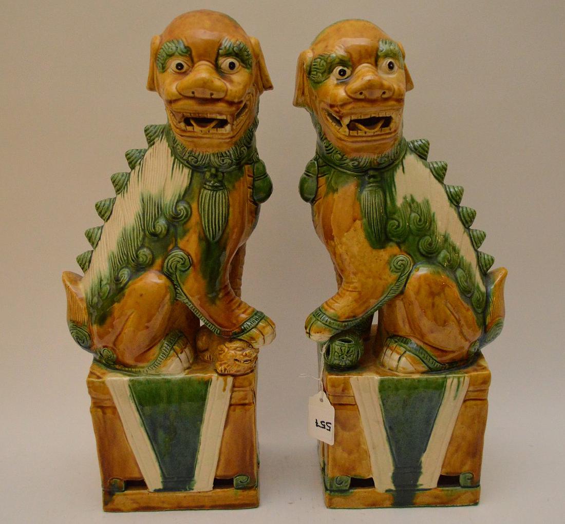 Pair of glazed pottery seated Chinese foo dogs, 15"h: Pair of glazed pottery seated Chinese foo dogs, 15"h