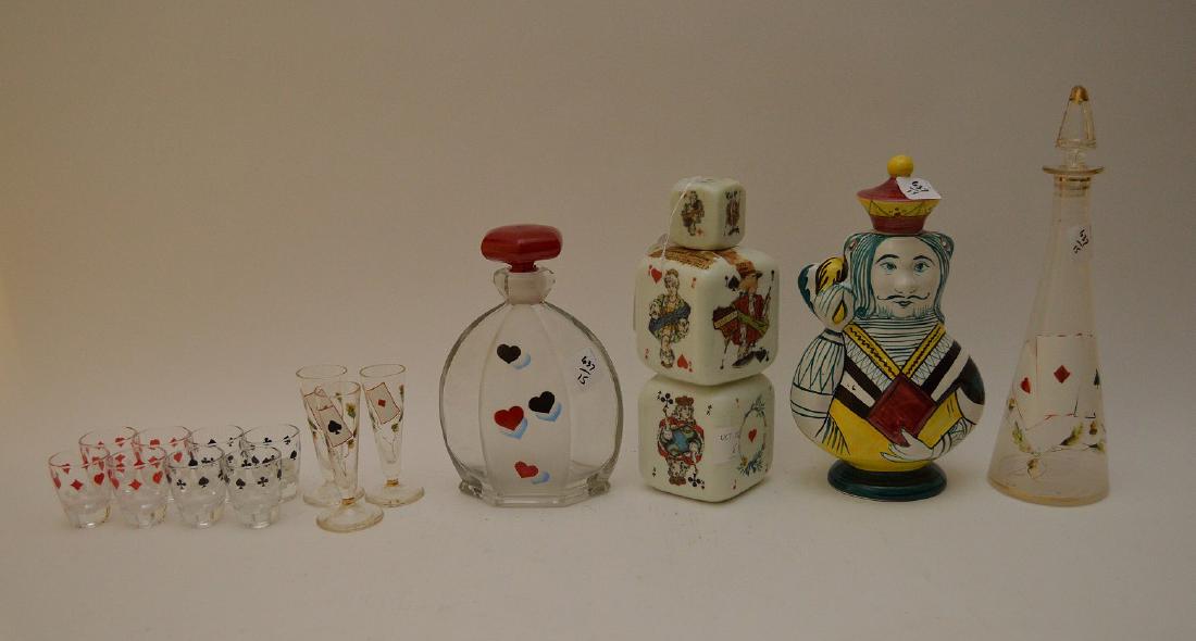 15 PCS DECANTER & GLASSES CARD MOTIF. One liquor: 15 PCS DECANTER & GLASSES CARD MOTIF. One liquor decanter blackberry liquor empty, one terra cotta has a chip on stopper and 2 glass decanter with glasses.
