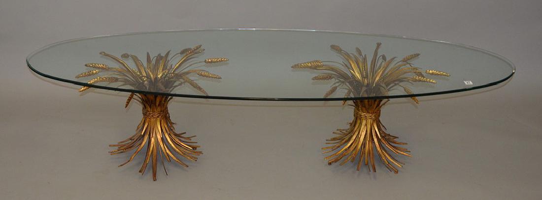 Mid Century coffee table, gilt metal wheat bundle: Mid Century coffee table, gilt metal wheat bundle supports with shaped glass top, 17"h x 71"w