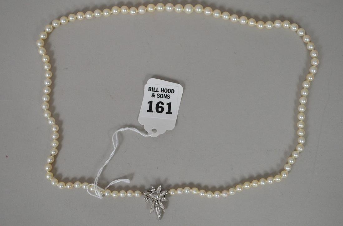 14k White Gold Diamond Clasp Pearl Necklace. Graduated: 14k White Gold Diamond Clasp Pearl Necklace. Graduated pearls 24" in good condition