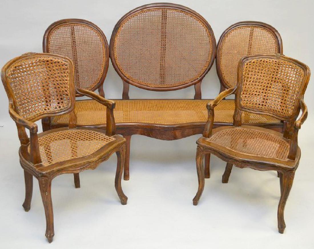 Louis XV Provincial Walnut Triple back settee, oval: Louis XV Provincial Walnut Triple back settee, oval backrests and serpentine framed cane seats, 44"h x 64"w x 23"d (good condition) with 2 caned arm chairs