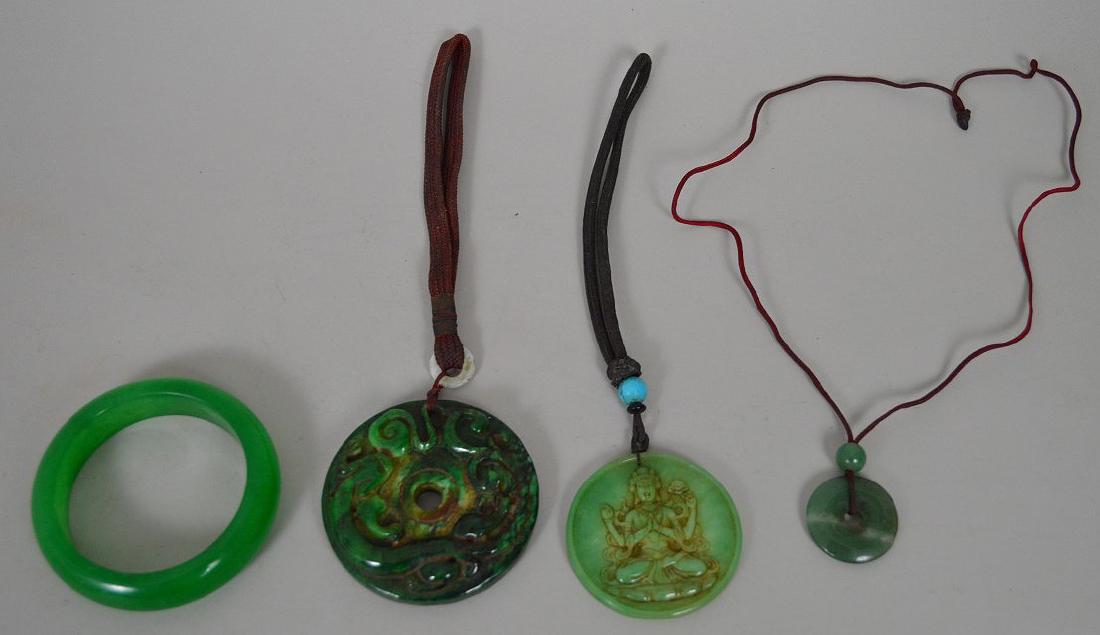 4 Chinese Jade Article 1 green bangle 7" inner: 4 Chinese Jade Article 1 green bangle 7" inner circumference, 2 Carved green stone pendant circle 2-3" & 1 circle stone pendant 1.25" condition normal wear