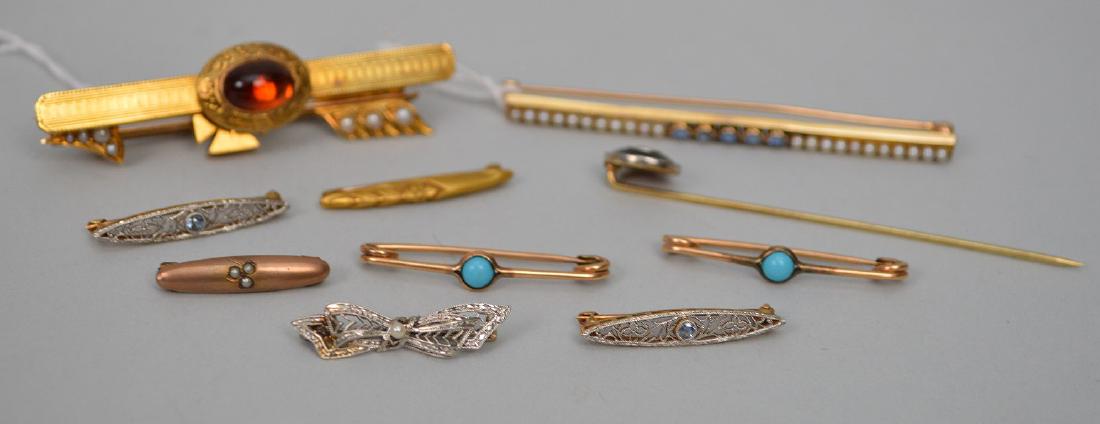 (11) 10 & 14k Gold Pins & Brooches. Some with seed: (11) 10 & 14k Gold Pins & Brooches. Some with seed pearls, turquoise, Sapphire, Baltic amber and diamonds. Size 1" -2.5". Condition good normal wear. Weight 23.7 grams This item is available for in ho