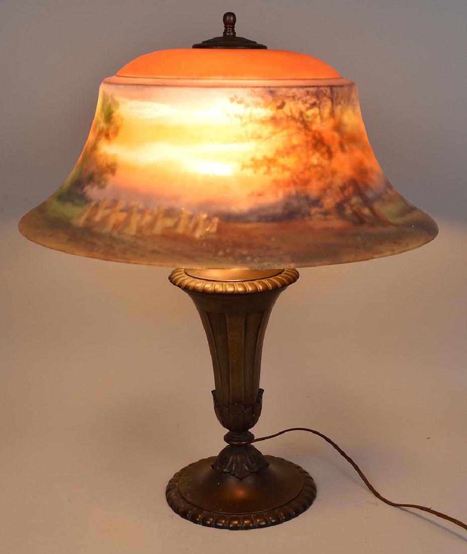 Signed Pairpoint Lamp with reverse painted landscape: Signed Pairpoint Lamp with reverse painted landscape glass shade on metal vase form base. Height 24" Width 20"