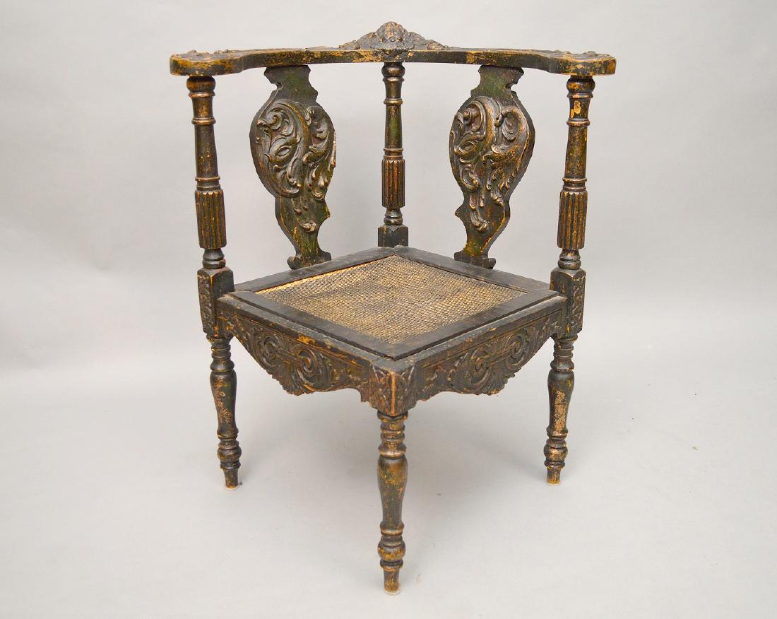 19th c. Carved corner chair with Cherub at crest and: 19th c. Carved corner chair with Cherub at crest and cane seat, 30 1/2"h x 26"w x 23"seat depth (some gilding showing)