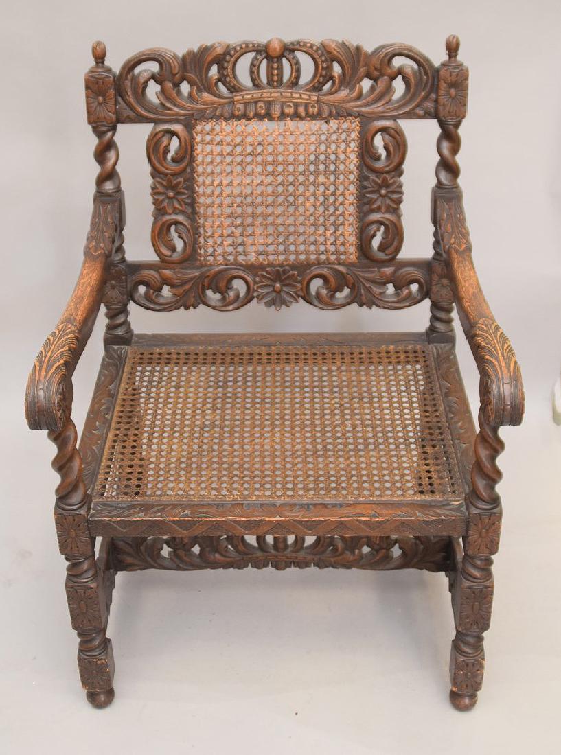 Continental heavily carved arm chair with caned back: Continental heavily carved arm chair with caned back panel & seat, carved Acanthus leaf motif and crown top at center crest, 36"h x 24 1/2"w x 24 1/2"d. from palm beach estate said purchased from Melo