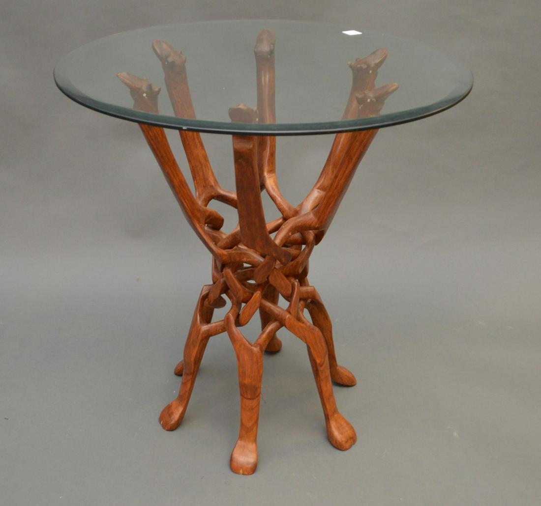 Carved African Wood Puzzle Table with beveled glass: Carved African Wood Puzzle Table with beveled glass top. Height 25" Diameter 24"