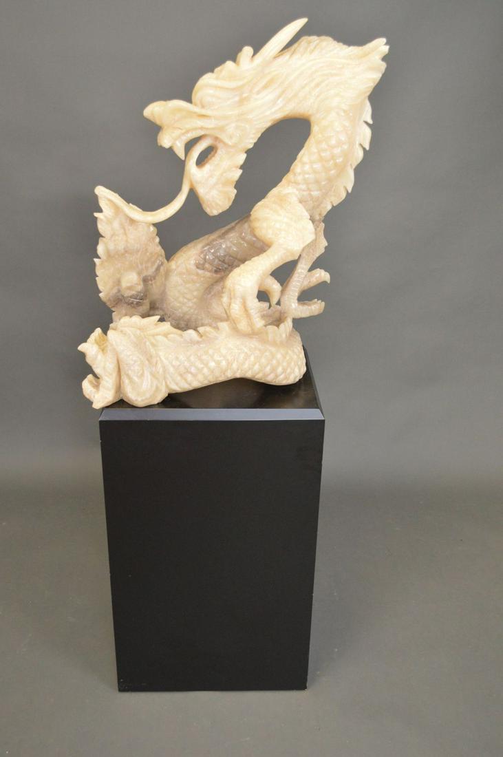 LARGE CARVED HARDSTONE CHINESE DRAGON. Condition: one: LARGE CARVED HARDSTONE CHINESE DRAGON. Condition: one toe has a chip, one scale on the dragons back has been glued. Height 29 1/2" Width 22 1/2" Depth 14 1/2"