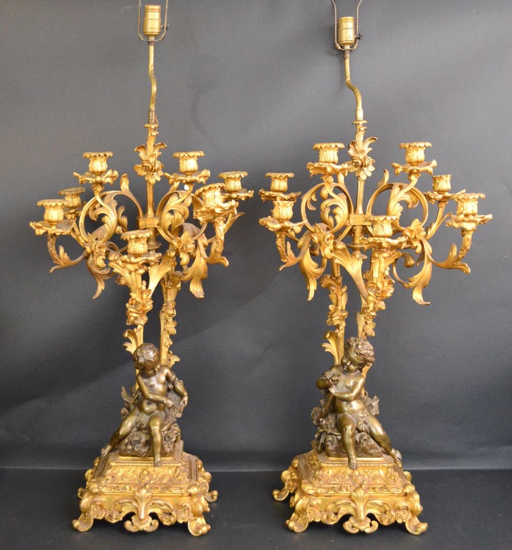 French 19th Century gilt bronze candelabra: French 19th Century gilt bronze candelabra, made into lamps, one does not have wire anymore, small repair to bronze at top see pics, candelabra size 28 x 15 inches. Overall size w/ harp and finial 49 