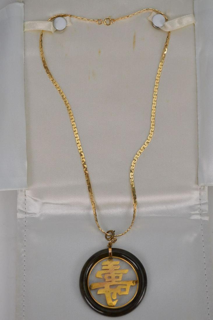 14K Yellow Gold & Jade Circular Pendant. Pendant 1.75": 14K Yellow Gold & Jade Circular Pendant. Pendant 1.75" circumference with center Chinese symbols marked 14k. Bale connector may not be 14k. Surrounded by Spinach Jade circle. Chain marked and tested t