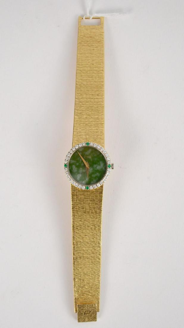 18K Yellow Gold Piaget watch. Diamond, Emerald Bezel: 18K Yellow Gold Piaget watch. Diamond, Emerald Bezel and malachite Dial. Women's analog watch. Serial # 9706- AG-158916. Weight 35.2 dwts Size 6"