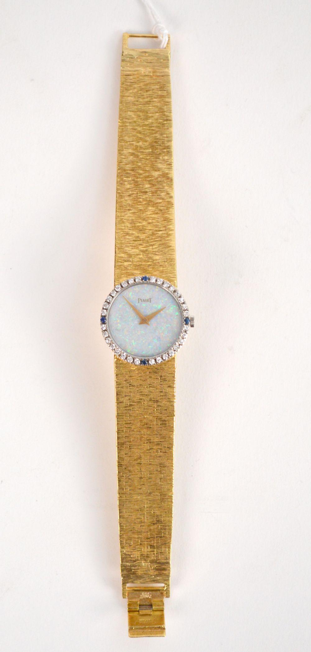 18K Yellow Gold Piaget Watch, Diamond Bezel & Sapphire: 18K Yellow Gold Piaget Watch, Diamond Bezel & Sapphire with Opal Face. Weight 38.5 dwts, size 6" serial # 9706-AG-136378