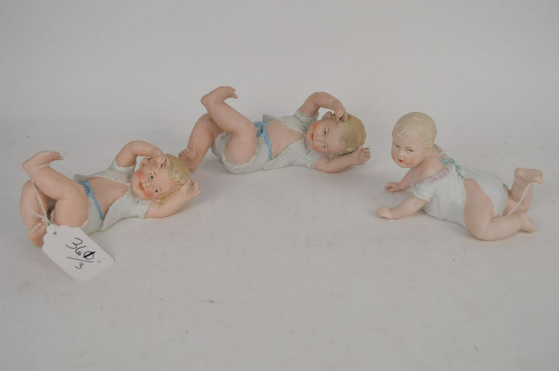 3 Heubach Bisque Piano babies, Germany, 2 laying (4"h x: 3 Heubach Bisque Piano babies, Germany, 2 laying (4"h x 10"w) AND 1 crawling (4 1/2"h x 7"w)
