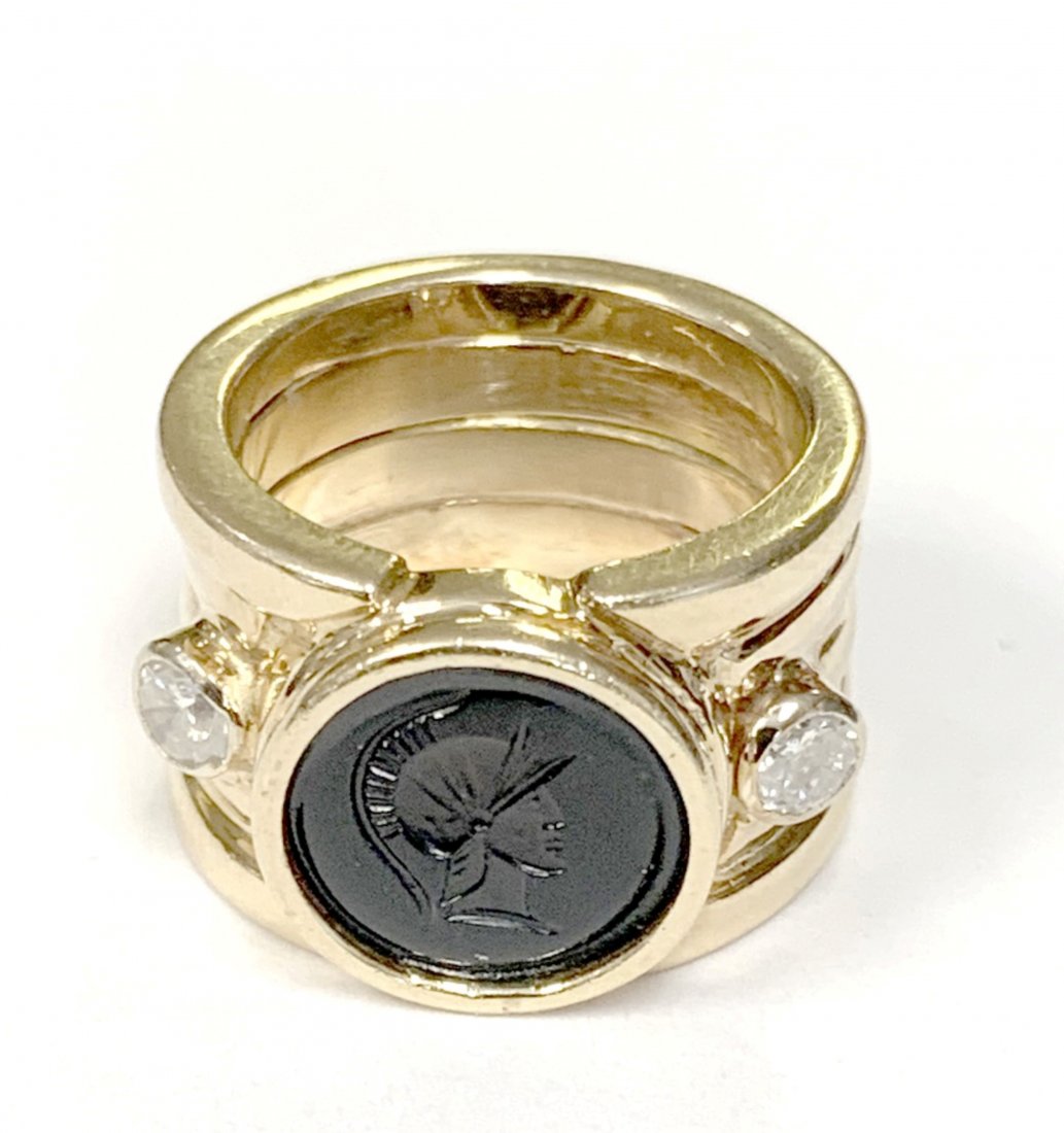 14KT LADIES INTAGLIO BAND RING 14kt yellow gold (not: 14KT LADIES INTAGLIO BAND RING 14kt yellow gold (not marked, acid tested) ladies wide band ring, bezel set with a round deep burgundy red glass Intaglio, bezel set with 2- 0.12cts, round full cut diam