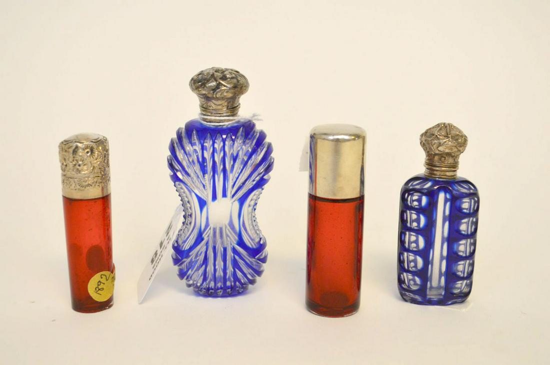 4 Antique Perfume bottles, 2 Cranberry with sterling: 4 Antique Perfume bottles, 2 Cranberry with sterling lids and 2 Cobalt cut to clear with silver lids, 3 3/4" tallest (flea bites on bottom edge of one)