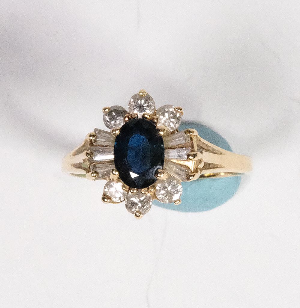 14k Yellow Gold Genuine Ceylon Sapphire Ring with: 14k Yellow Gold Genuine Ceylon Sapphire Ring with Sputnik Diamond Enhancer . 1.50 dtw, assembled with a 1.25 carat Ceylon sapphire, 6 (3mm) tapered baguettes SI-1, and 6 (2mm) SI-1 round cut. Size 7-7