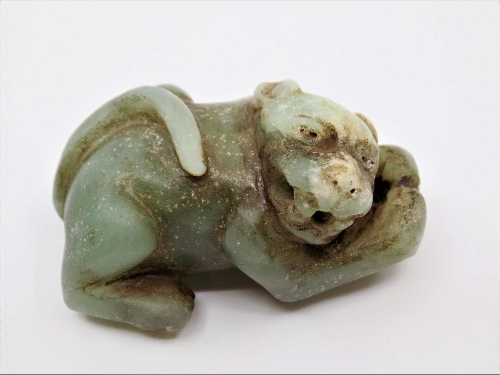 Pre-Columbian Jade Jaguar Miniature, Jade Pendant Form: Pre-Columbian Jade Jaguar Miniature, Jade Pendant Form of a feline Jaguar, Translucent Green Jade, Mineral Deposits and Obvious Signs of Erosion, Finely Carved, Dimensions: 2" x 1 1/4", Origin: Northe