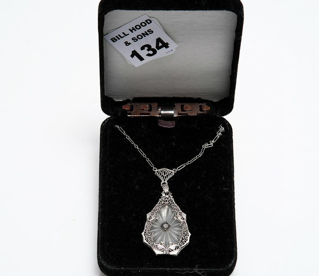 Art Deco 10k White Gold Filigree Camphor Glass with: Art Deco 10k White Gold Filigree Camphor Glass with Diamond Center. Good Condition normal wear. Weight 5.3 grams Size 16" Pendant 2" x 1"