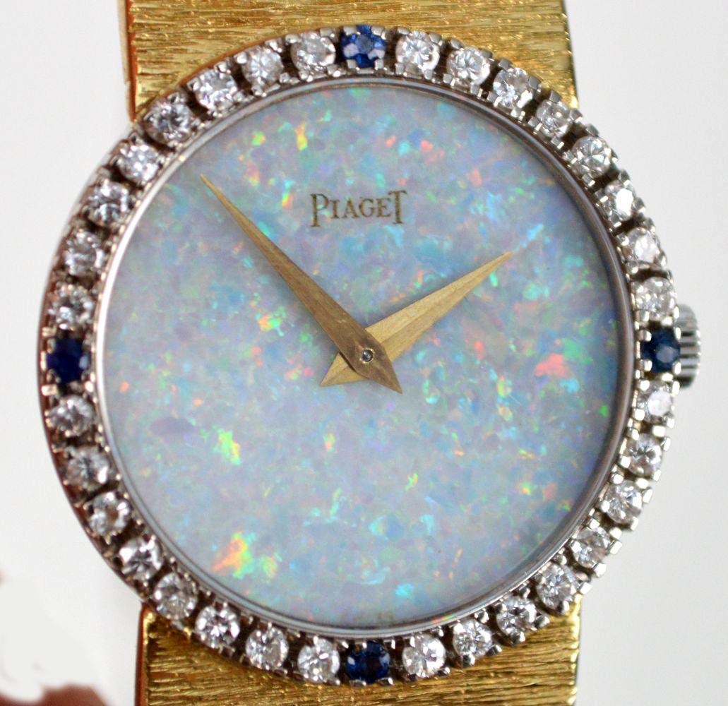 18K Yellow Gold Piaget Watch Diamond Bezel Opal face: 18K Yellow Gold Piaget Watch Diamond Bezel Opal face 18K Yellow Gold Piaget Watch, Diamond Bezel & Sapphire with Opal Face. Weight 38.5 dwts, size 6" serial # 9706-AG-136378. condition- band has been 