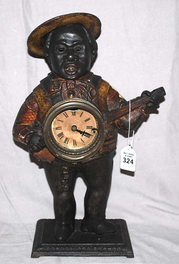 Cast iron figure of Afro-American strumming a banj