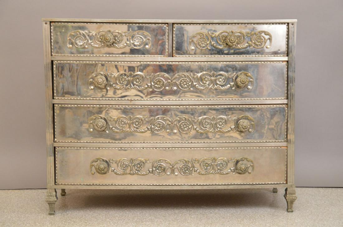 VINTAGE 5 drawer chest, silvered metal front with: VINTAGE 5 drawer chest, silvered metal front with mirrored top & ends and silvered metal mount accoutrements, 29"h x 26"w x 17"d (Back right leg loose)